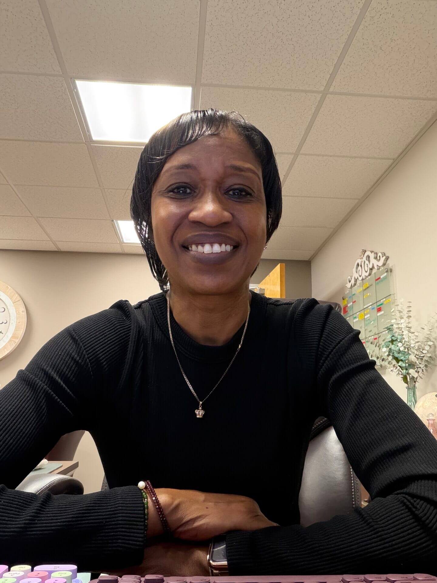 Smiling woman sitting in an office.